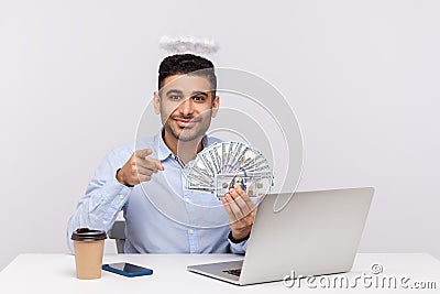 Hey you, make money online! Angelic rich businessman with nimbus on head pointing to camera Stock Photo