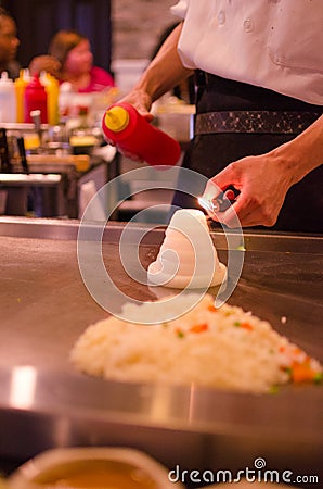 Hibachi restaurant chef preparing meal and entertaining guests Editorial Stock Photo
