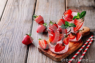 Hibiscus strawberry rhubarb iced tea with mint. Ice cold summer cocktail or lemonade in mason jar Stock Photo