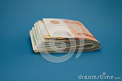 hick stack of cash money. The concept of rich, wealth, profits, business and finance. Five thousandth bills banknotes Stock Photo