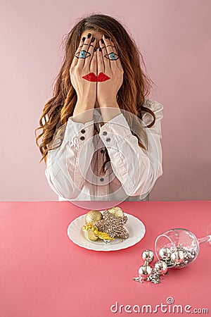 Hidden emotions, surreal girl with face drawn on her hands . Minimal creative composition with sparkling details ,against pink Stock Photo