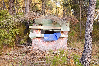 Hidden hunting post camouflaged in a forest Stock Photo