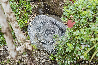 A hidden weatherproof rock speaker blending into an outdoor landscaped garden Stock Photo