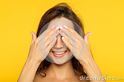 Hide seek smiling joyful girl covering eyes hands Stock Photo