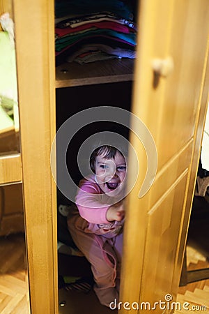 Hiding in closet Stock Photo