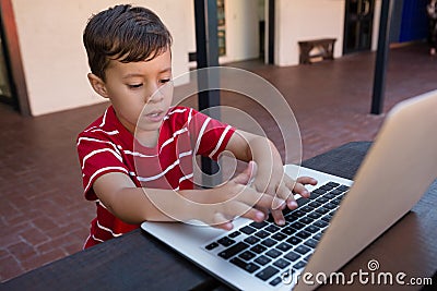 High agle view of boy using digital laptop while sitting at table Stock Photo