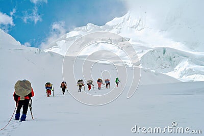 High Altitude Porters aproaching the highest trekking pass Verjerav that connects Shimshal valley with Snow Lake Stock Photo