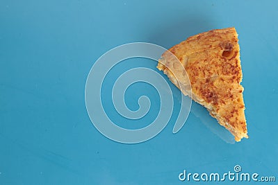 High angle closeup shot of a piece of potato omelet skewer on a blue background Stock Photo