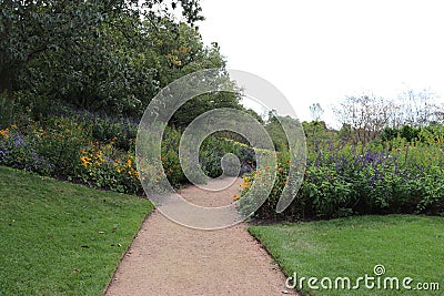 High-angle of a dusty path through grass and plants on both sides Stock Photo