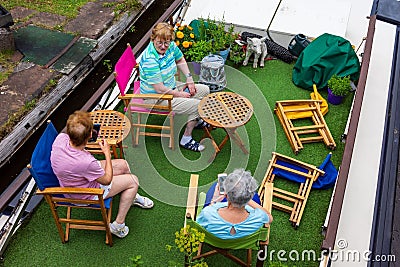 High angle of a group of older women sitting at Bridgewater Canal swing bridge at Barton Editorial Stock Photo