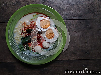 High angle photo of a bowl of instant noodle soup with coconut milk Stock Photo