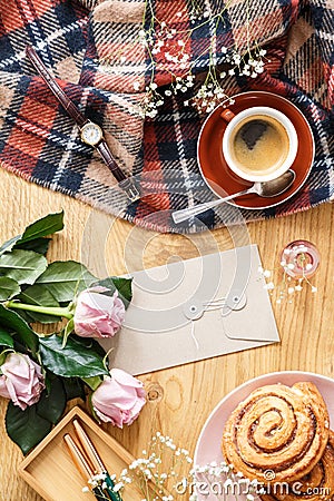 High angle on pink roses on wooden desk with cup of coffee and b Stock Photo