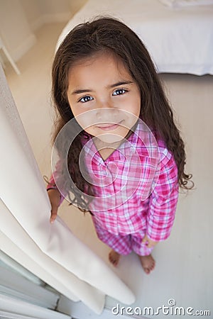 High angle portrait of a smiling girl in bedroom Stock Photo