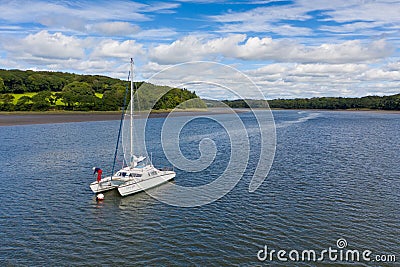 High-angle shot of a catamaran sailing boat in the river Cleddau on a sunny day Editorial Stock Photo