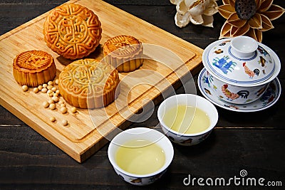 High angle shot of cookies and cups of herbal tea on a wooden surface Stock Photo