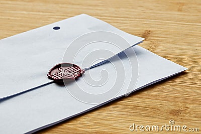 High angle shot of an envelope sealed with wax on a wooden surface Stock Photo