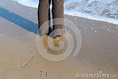 High angle shot of a male's shoeprint on the beach sand Stock Photo