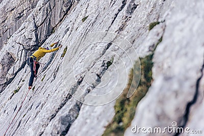 High angle shot of a person climbing a rock in the Alps in Austria - overcoming challenges concept Editorial Stock Photo