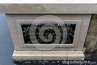 High angle shot of the sign with text regarding foundation of bridge Saint Michel in Paris Stock Photo