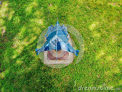 High angle shot of a steel blue sculpture and a green grass Editorial Stock Photo