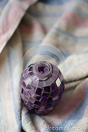 High angle shot of a violet decorative vase put on a towel Stock Photo