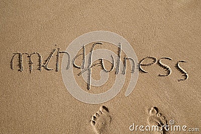 Word mindfulness in the sand Stock Photo