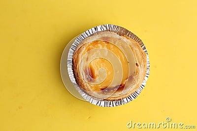High angle top view closeup shot of cheese quiche on a yellow table Stock Photo