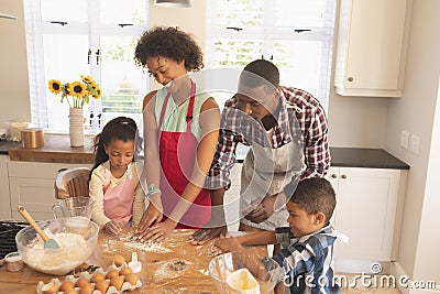 African American family baking cookies in kitchen Stock Photo