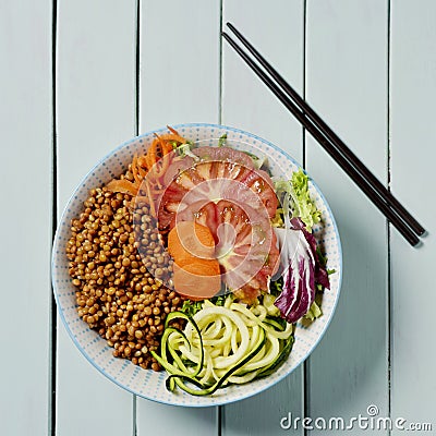 Buddha bowl salad on a pale green table Stock Photo