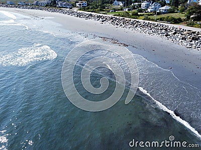 High angle view of a beautiful wavy sea and the shoreline with buildings Stock Photo
