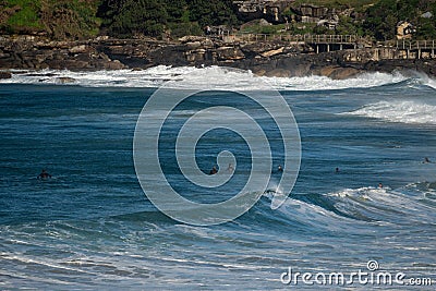 High-angle view of Bondi Beach surfers sitting out the back of the surf waiting for a wave to catch Stock Photo