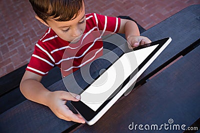 High angle view of boy using tablet while sitting at table Stock Photo