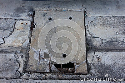 Damaged reinforced concrete drain cover Stock Photo
