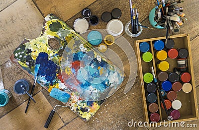 High angle view of brushes, pallete, oils, acrylics and other elements of a painter artist. Art workshop. Background Stock Photo