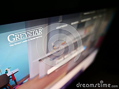 High angle view of business website with logo of US apartment company Greystar Real Estate Partners LLC on monitor. Editorial Stock Photo