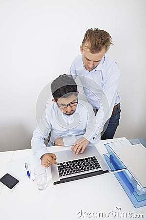 High angle view of businessmen using laptop in office Stock Photo