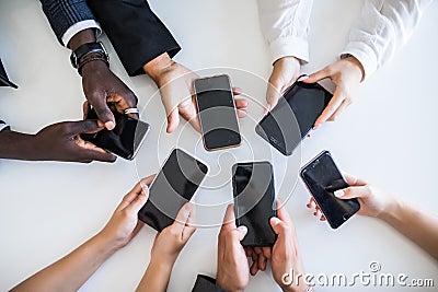 High Angle View Of Businesspeople Hand Using Mobile Phones. Addiction on networks Stock Photo