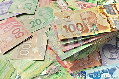 High Angle View of Canadian Banknotes of Different Values with a Large Stack of Bills on Top Stock Photo