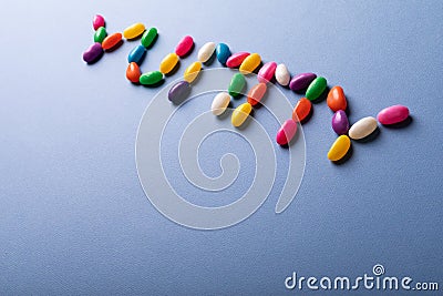 High angle view of colorful yummy word arranged from candies over copy space on blue background Stock Photo