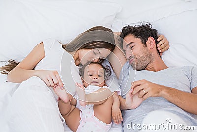 High angle view of couple loving baby on bed Stock Photo