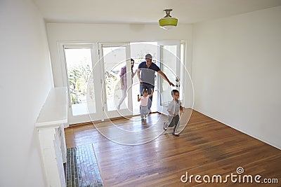 High Angle View Of Family Exploring New Home On Moving Day Stock Photo