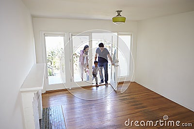 High Angle View Of Family Exploring New Home On Moving Day Stock Photo