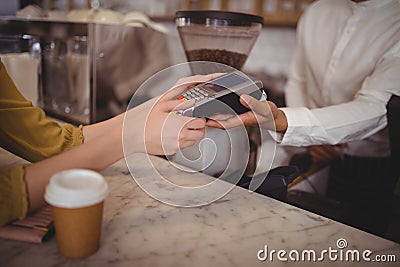 High angle view of female customer paying through debit card at counter Stock Photo