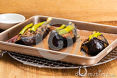 High angle view of freshly baked turkish food, turkey stuffed eggplants - karniyarik in tray metal ovenware Stock Photo