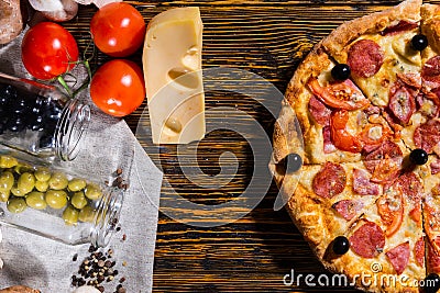 High angle view of half of pepperoni pizza with olives, near lie Stock Photo