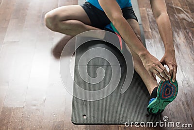 High-angle view of the hands of a man touching his toes as a str Stock Photo