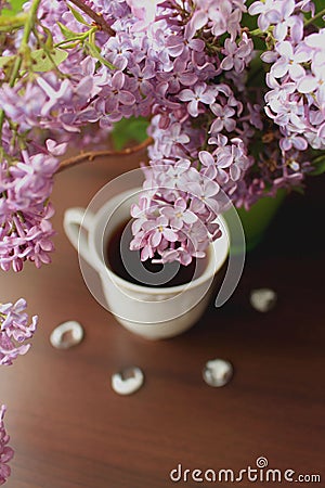 High angle view of lilac branch and cup of tea Stock Photo