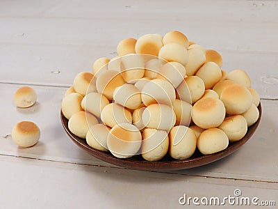 High angle view of little ball cookies on wooden plate isolated on wooden background. Stock Photo