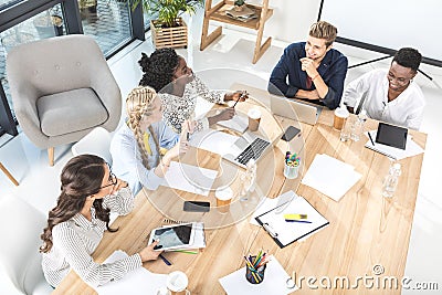 high angle view of multicultural group of business people discussing work Stock Photo