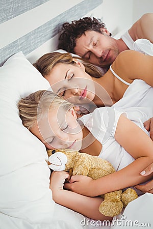 High angle view of parents sleeping with daughter Stock Photo